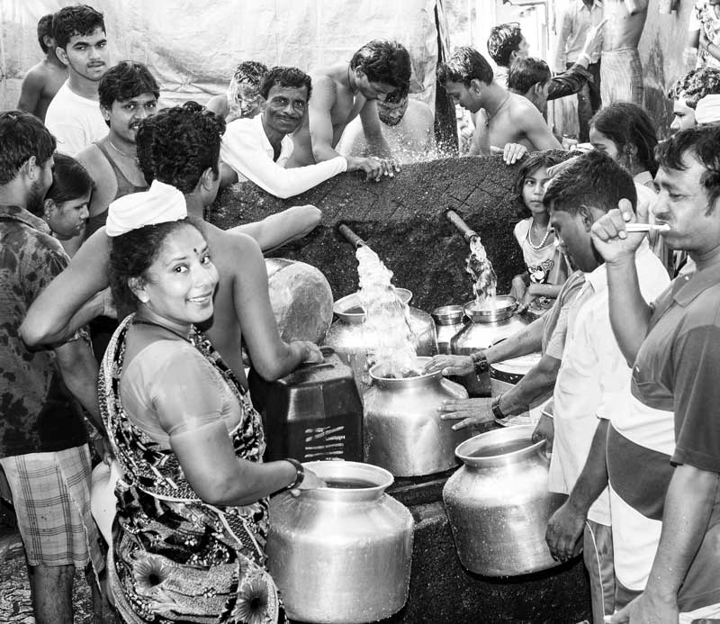 Rush for water at a public standpoint at dawn in Mumbai, Maharashtra